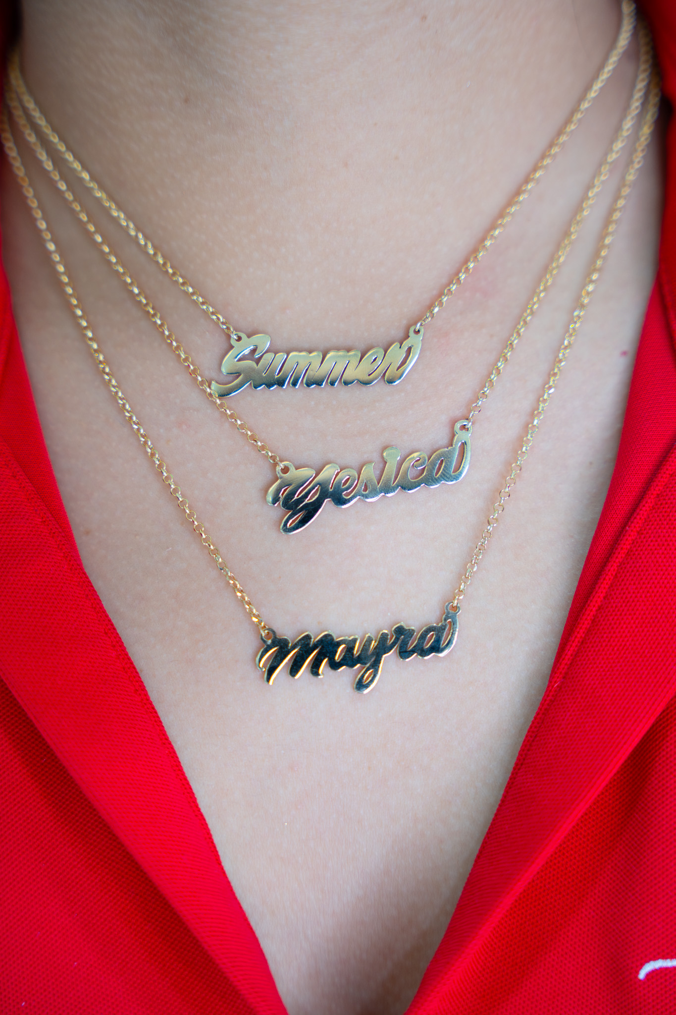 Tres collares de oro con nombres personalizados usados en capas